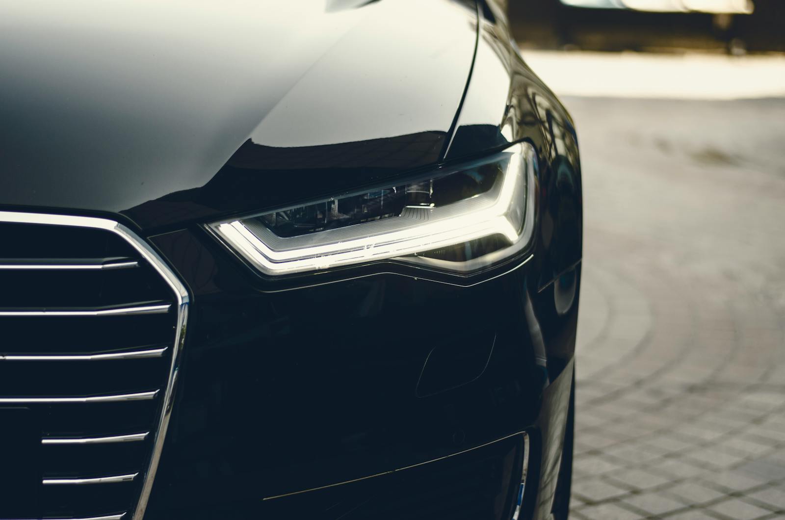 auto A sleek, modern luxury car showcasing its chrome detailing and LED headlights on a city street.