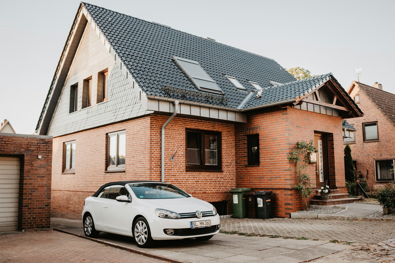 white Volkswagen Jetta parked beside house, home and auto